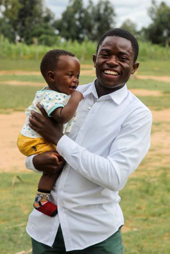 smiling father holding son