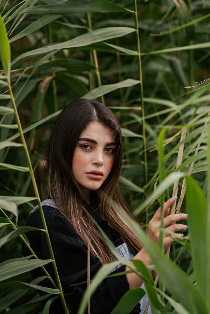 portrait of a young woman in lush greenery