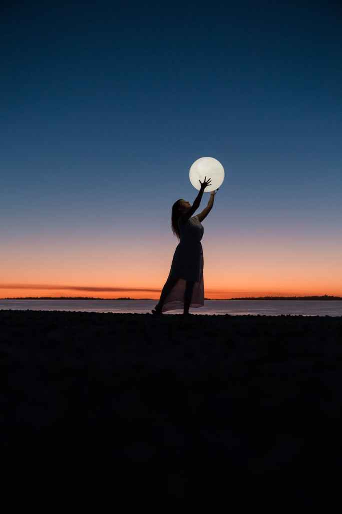 woman holding a moon