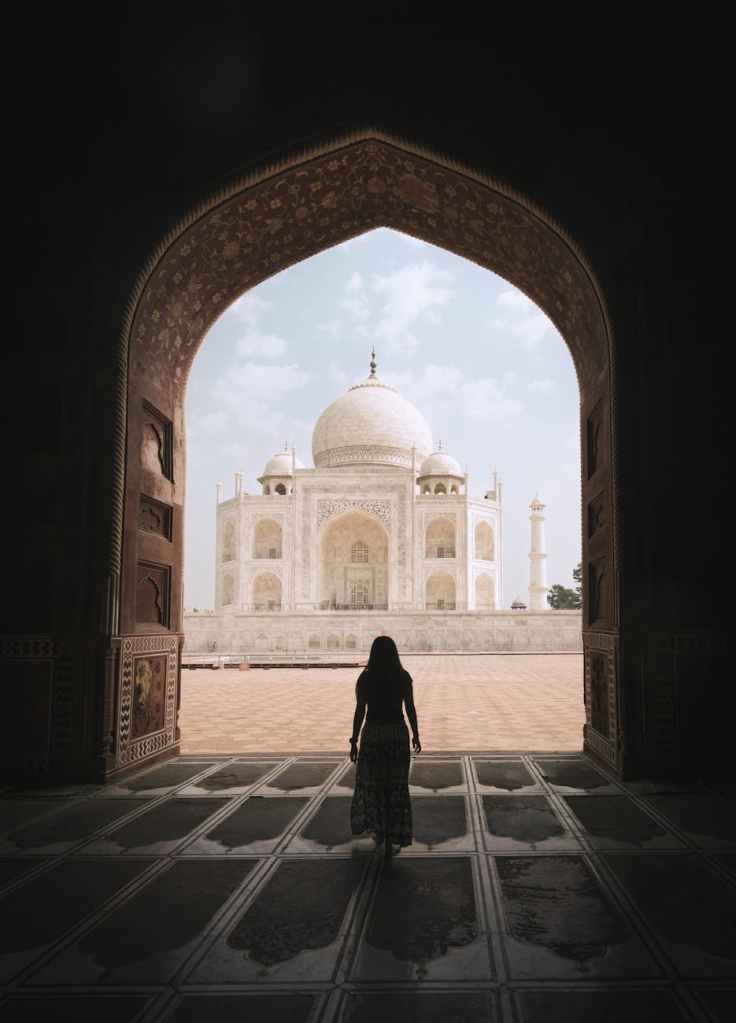 woman admirning the majestic taj mahal