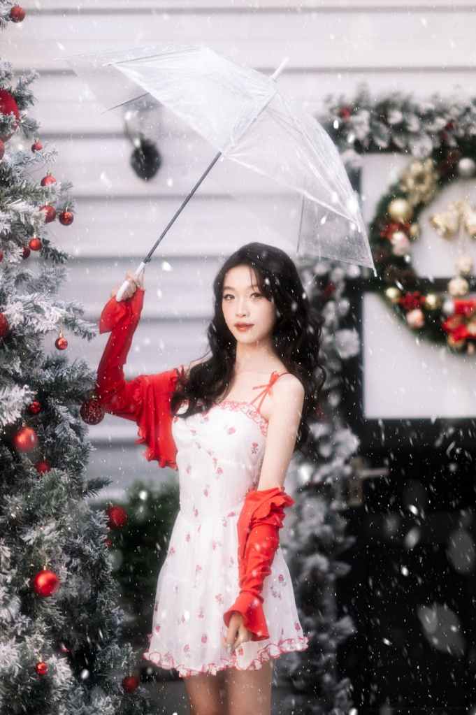 festive portrait of woman in snow with umbrella